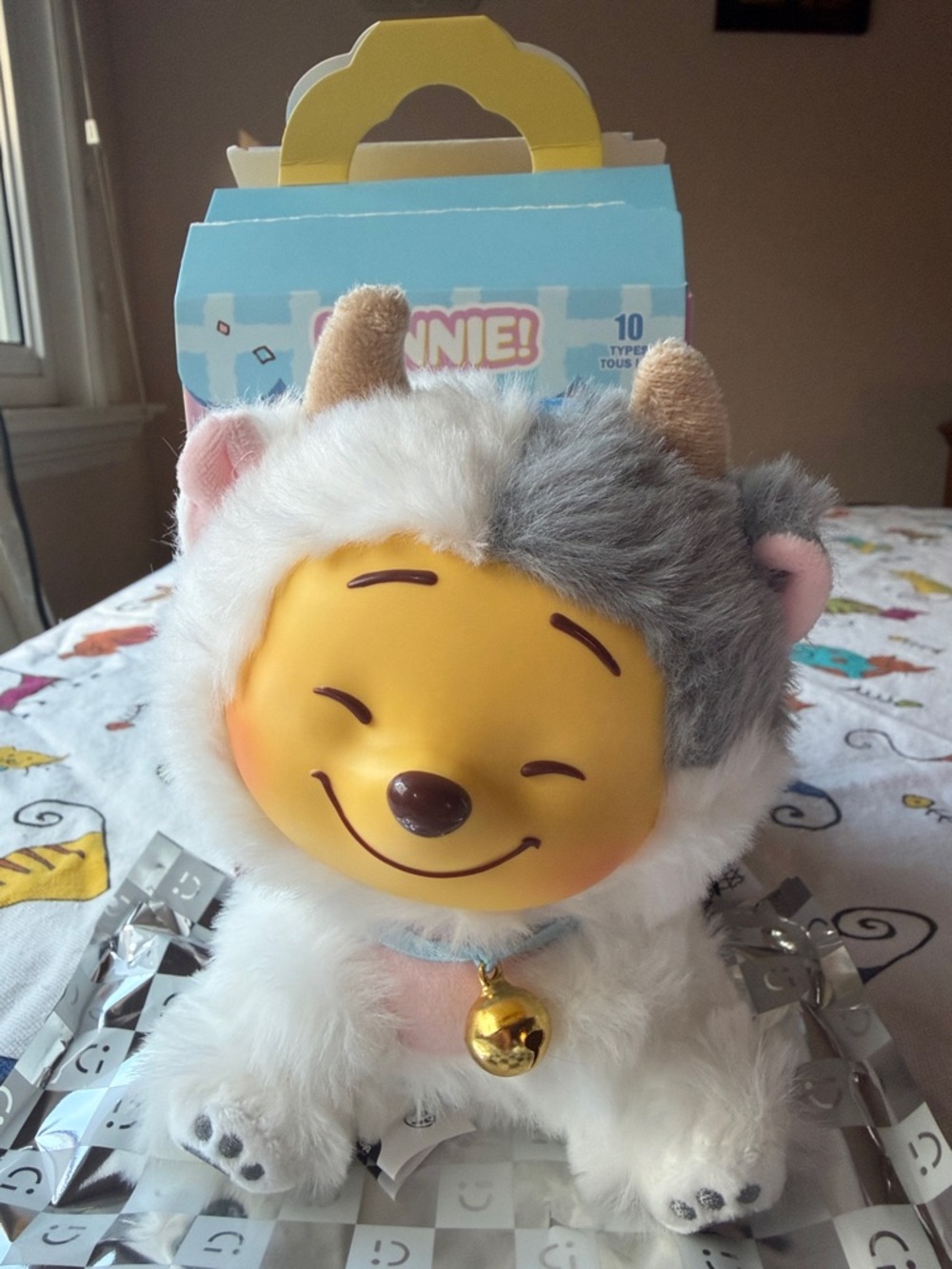 Smiling Plush Toy with Gold Bell - Yellow Face, White & Gray Fur